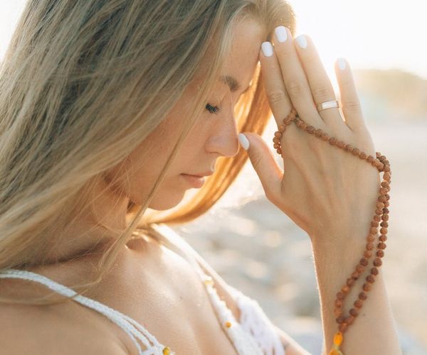 Person meditating with a serene look, symbolizing mind-body connection.