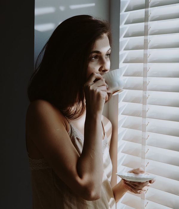 Woman performing a gentle morning exercise in a calm environment.